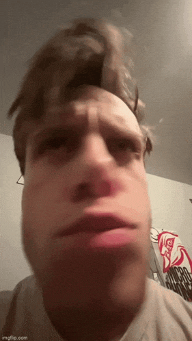 a close up of a man making a funny face with his mouth open .