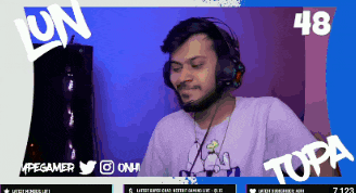 a man wearing headphones is sitting in front of a screen with the number 48