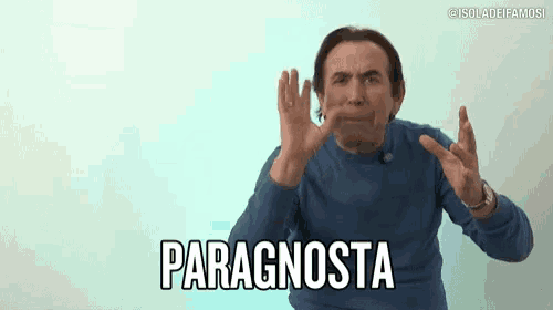 a man in a blue sweater is making a gesture with his hands and the word paragnosta is on the screen behind him