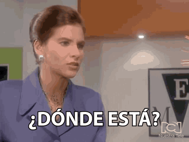 a woman in a purple suit is saying donde esta