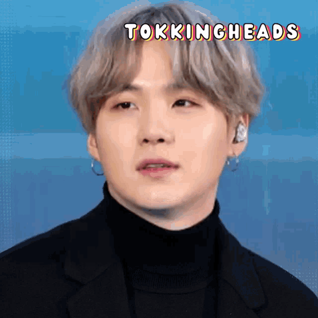 a close up of a man 's face with the words tokingheads written above him