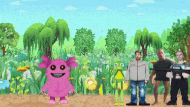 a group of people are standing in a field with a pink monster and a frog