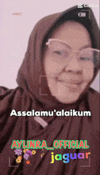 a woman wearing glasses and a scarf says assalamu ' alaikum