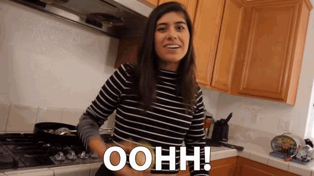 a woman in a kitchen with the word ohhh written on the counter