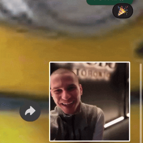 a picture of a smiling man is displayed on a screen