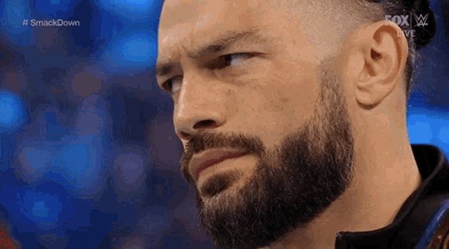 a close up of a man with a beard on a wrestling show .