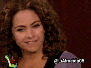 a woman with curly hair is smiling and has the hashtag @ lialmeida05