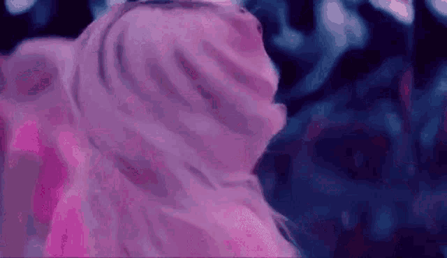 a close up of a woman 's hair in a pink dress .