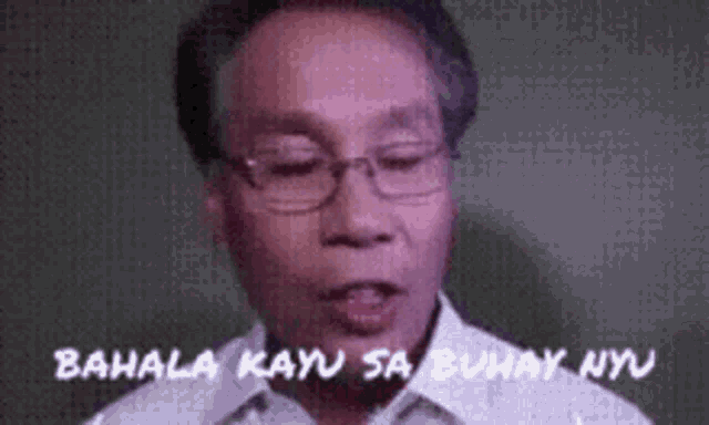 a man wearing glasses and a white shirt is talking in a video .