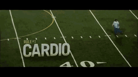a man is running on a football field with the word cardio written on the field