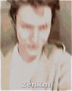 a blurry picture of a man with zenxn written on the bottom right