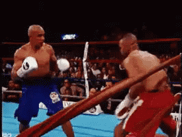 two men are boxing in a ring and one of them has the number 9 on his glove