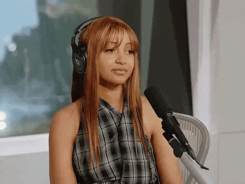 a woman wearing headphones with the letter b on it