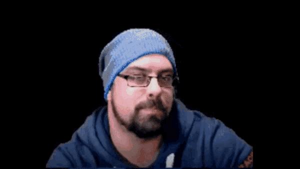 a man with a beard wearing a blue sweatshirt that says ' a ' on it
