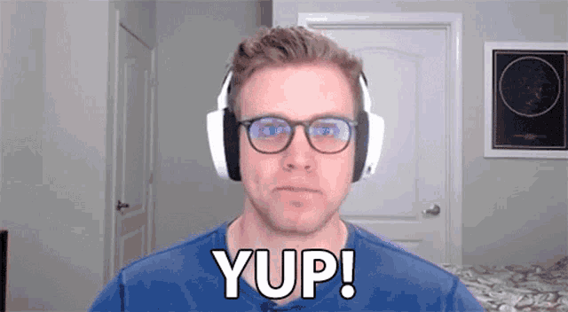 a man wearing headphones and glasses says yup !