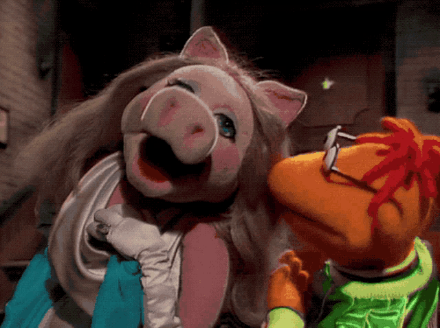 miss piggy and mr. piggy are standing next to each other in a dark room