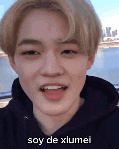 a close up of a person 's face with the words soy de xiumei written on it