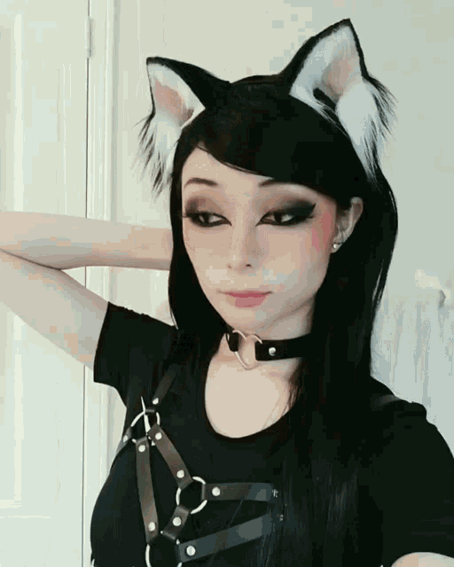 a woman wearing cat ears and a choker