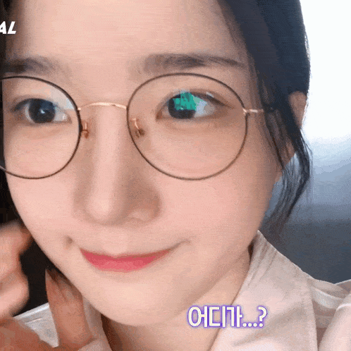 a close up of a woman 's face with glasses and a question mark in blue