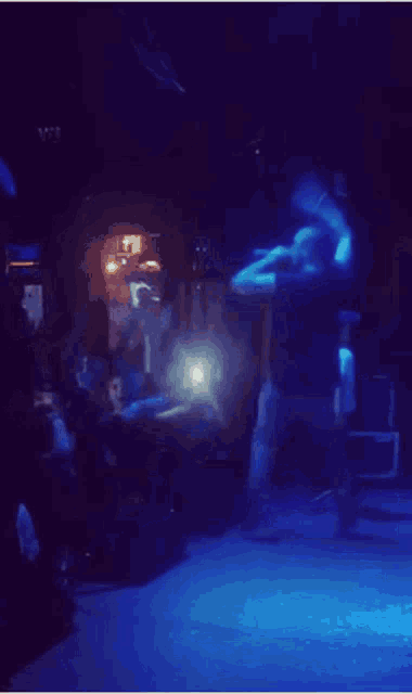 a man stands on a stage in front of a crowd of people