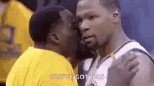 two basketball players are kissing each other on the cheek .