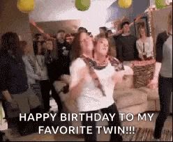 a group of people are dancing at a birthday party and a woman is dancing with another woman .