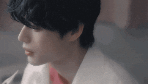 a close up of a person 's face with black hair