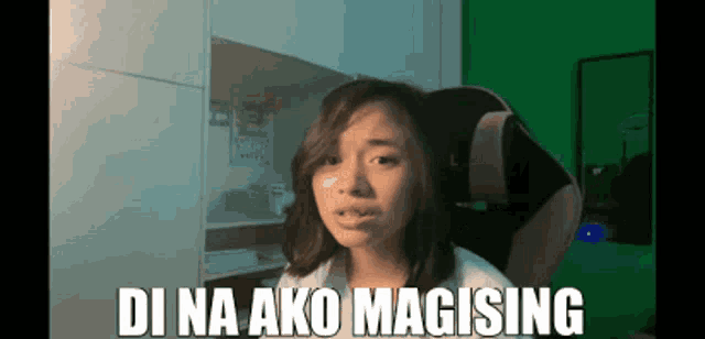 a girl is sitting in a chair with the words di na ako magising written above her