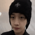 a close up of a person wearing a black beanie .