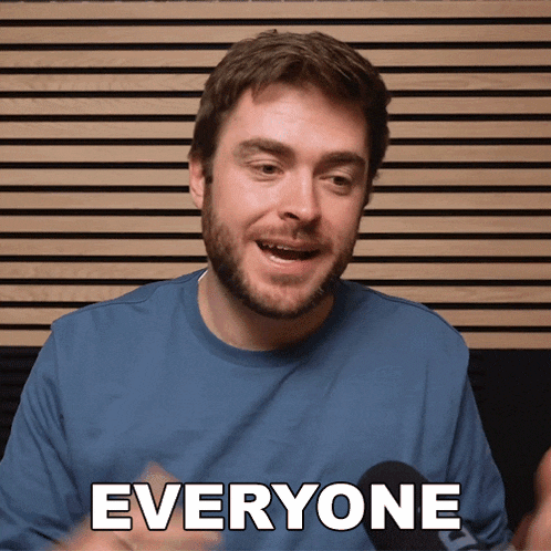 a man wearing a blue shirt with the word everyone on it