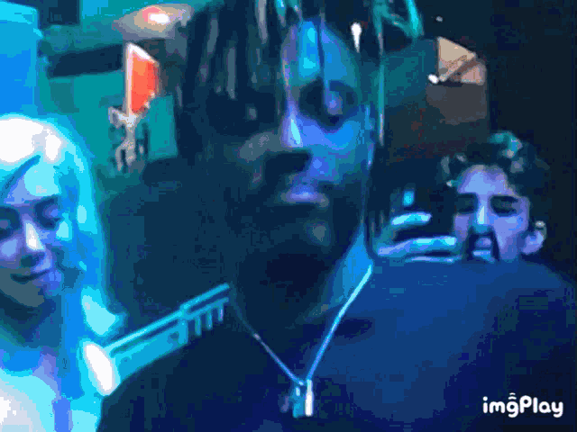 a gif of a man with dreadlocks and the word imgplay on the bottom right