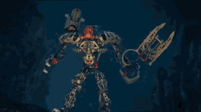 a toy robot with a sword and a hammer standing in the water