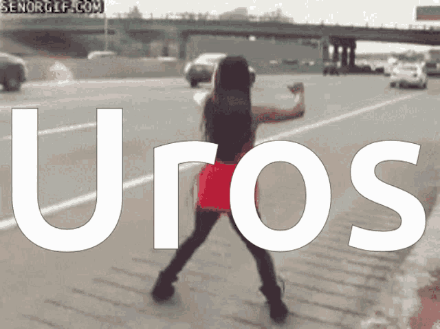 a woman is dancing on the side of a highway with the word uros in white letters