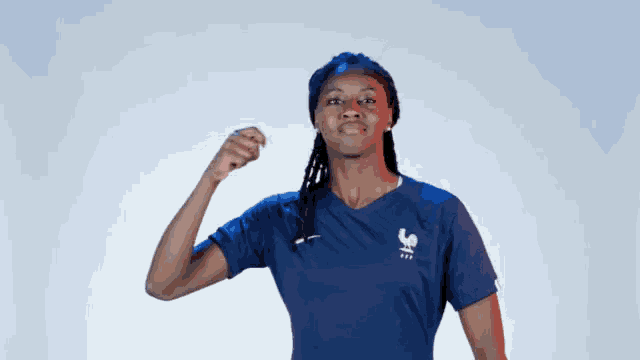 a woman wearing a blue shirt with a rooster on the front