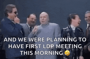 a group of men are standing next to each other laughing and talking .