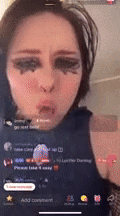 a woman with makeup on her face is making a funny face on a cell phone screen .