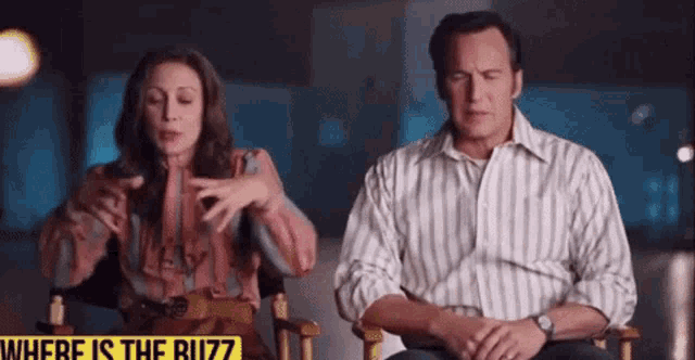 a man and a woman are sitting next to each other in a chair .