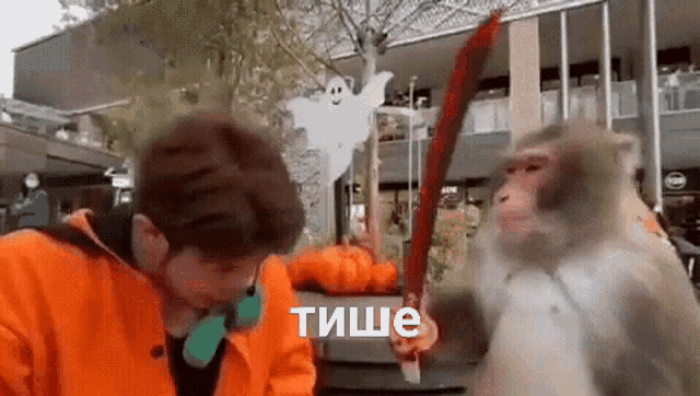 a man is being attacked by a monkey while holding a sword .