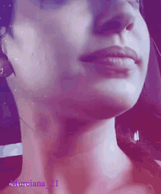 a close up of a woman 's face with a purple background and the name marciana 21