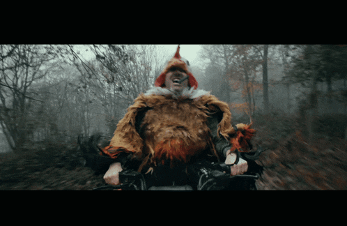 a man wearing a chicken costume is riding a bike