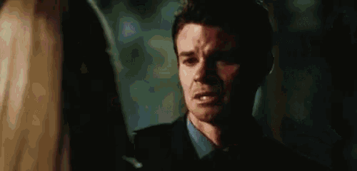 a man and woman are standing next to each other in a dark room .