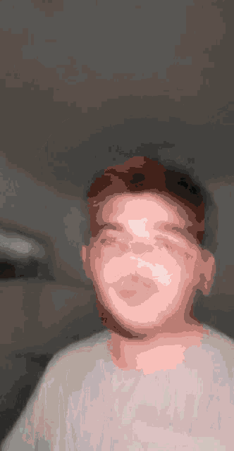 a man with a beard is taking a selfie with his eyes closed .