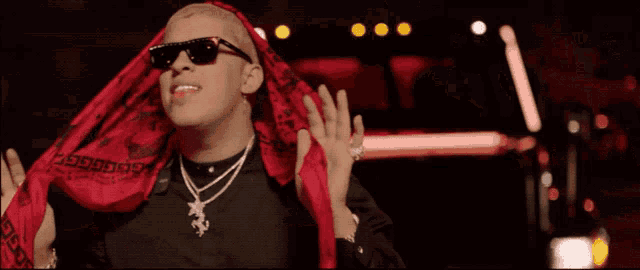 a man wearing sunglasses and a scarf around his head with the word gucci on it