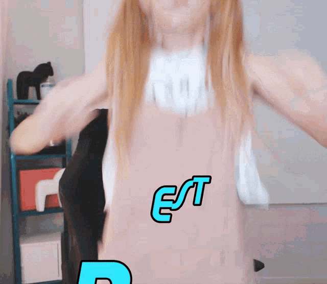 a woman in a pink dress with the word est written on it