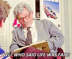 a man reading a book with the words well who said life was fair behind him
