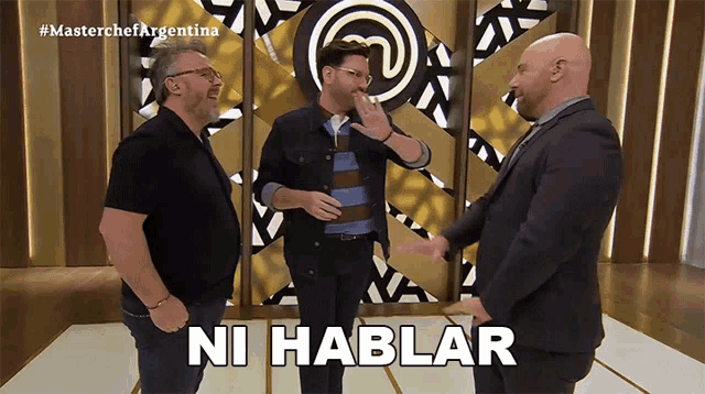 three men are standing in front of a wall with the words ni hablar on it