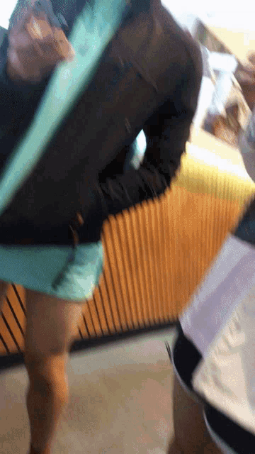 a blurry picture of a person standing in front of a wooden counter