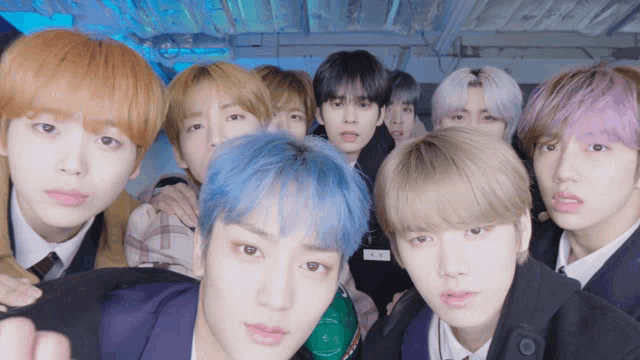 a group of young men with blue hair are posing for a picture together