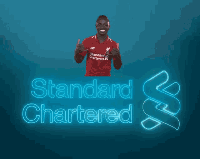 a man in a red shirt that says standard chartered