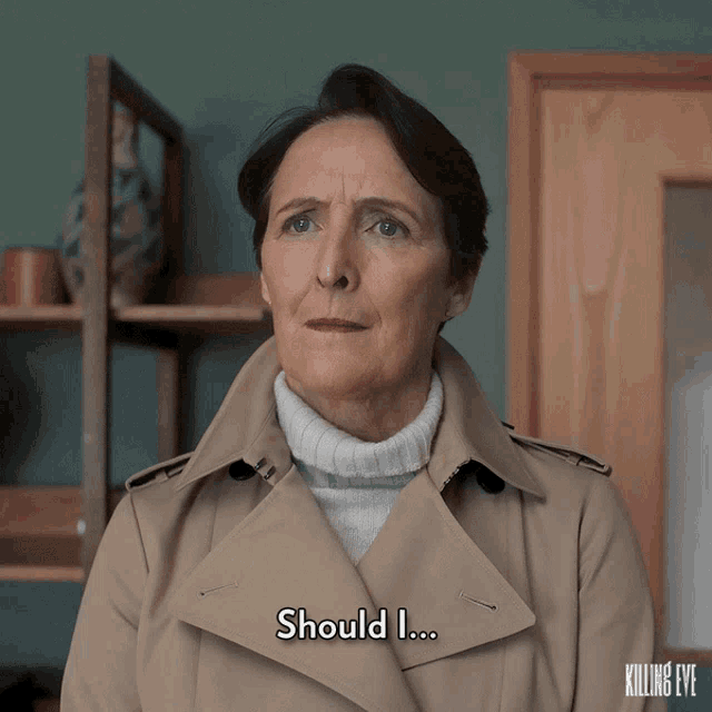 a woman wearing a trench coat says should i